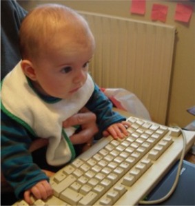 This youngster is getting an early start using a computer.